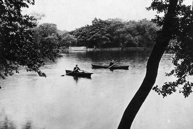 A postcard view of the Upper Lake at Roundhay Park with a postdate of August 24, 1930. Two rowing boats are seen in the centre of the lake.