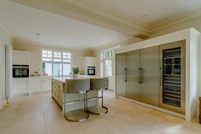 The fitted kitchen with island unit has a fireplace with wood burner, a bay window and doors leading out to a south facing terrace.