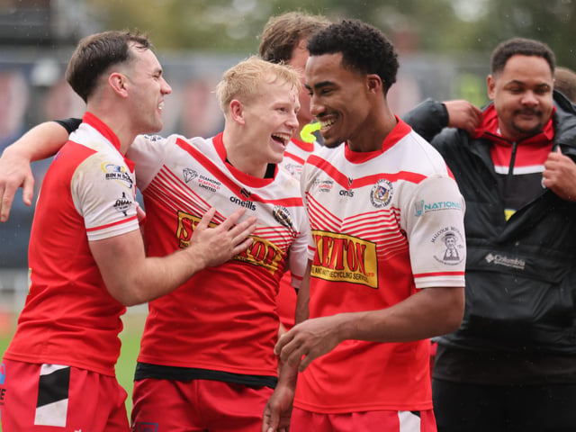 East Leeds' Owen Hughes, Alfie Crawford and David Kamano celebrate victory agianst Oulton Raiders in the National League Division One play-off final at Wakefield Trinity.