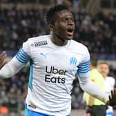 Marseille's Senegalese forward Bamba Dieng celebrates his team's first goal during the French L1 football match between RC Strasbourg Alsace and Olympique de Marseille (OM) at Stade de la Meinau in Strasbourg, eastern France on December 12, 2021. (Photo by SEBASTIEN BOZON / AFP) (Photo by SEBASTIEN BOZON/AFP via Getty Images)