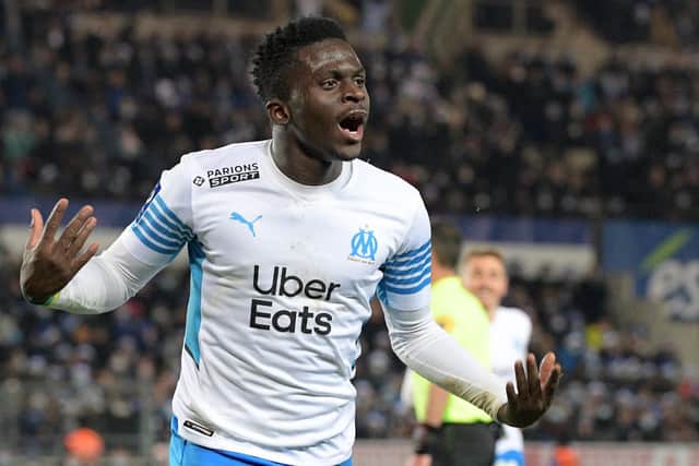 Marseille's Senegalese forward Bamba Dieng celebrates his team's first goal during the French L1 football match between RC Strasbourg Alsace and Olympique de Marseille (OM) at Stade de la Meinau in Strasbourg, eastern France on December 12, 2021. (Photo by SEBASTIEN BOZON / AFP) (Photo by SEBASTIEN BOZON/AFP via Getty Images)