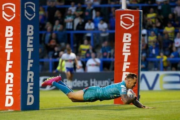 Richie Myler scores for Rhinos in their win at one of his former clubs, Warrington Wolves, in June, 2023. Picture by Ed Sykes/SWpix.com.