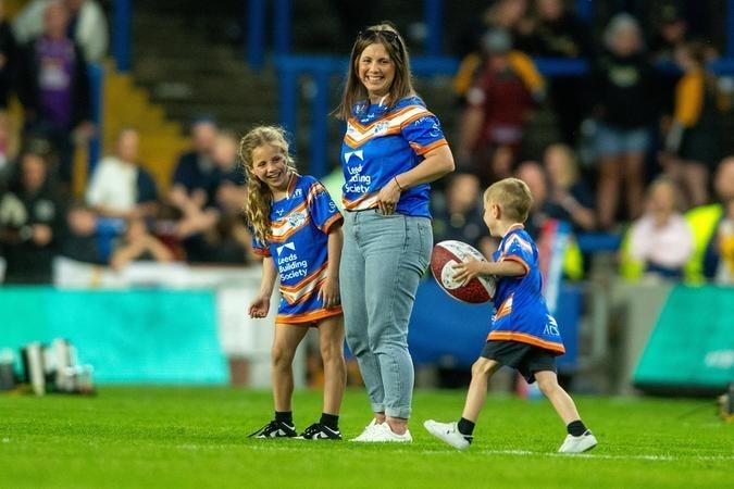 Rob Burrow's wife Lindsey and children Maya and Jackson on the pitch at AMT Headingley.
