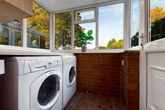 The utility room is fitted with a matching range of wall and base units in white gloss, with plumbing for a washing machine, space for a tumble dryer and UPVC double glazed door to the side elevation