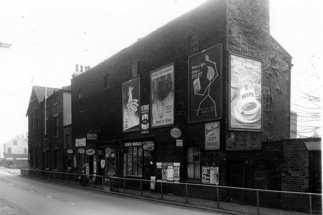 Burley Road in October 1959. On the left, at the corner with Roberts Place is Burley Liberal Club. After this building was demolished a new club was built a short distance away at the corner of Willow Road and Burley Road. Moving right are numbers 187, 189 which is a tobacconists shop, then 191 a newsagents, business of L and B Terrill. There are a number of large posters on the wall, the middle one is titled 'British Achievements Britain Leads the way in Radar-Speak for Britain'.