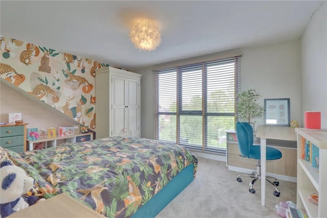 A super double bedroom at the rear of the house with those lovely garden views from the fantastic floor-to-ceiling picture window. There is a fifth bedroom with a floor-to-ceiling window to the rear elevation, pleasant garden views and feature bold decor theme.