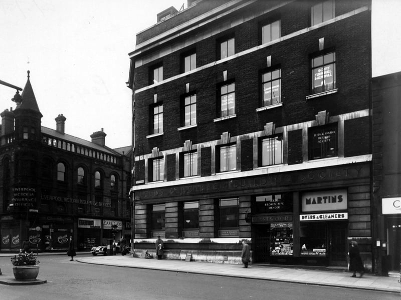 The Headrow at the junction with Albion Street pictured in May 1951. Premises shown are (on Albion Street), The Liverpool Victoria Insurance Co.; The Chocolate Box, confectioners; W.E Edgerton, pastry cook; Carl & Co., gowns. On the right (on The Headrow) are; The Leeds & Holbeck Building Society; G. Eastwood, tobacconist and Martins Ltd., dyers and cleaners.