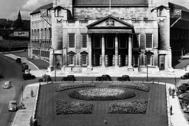 August 1949 and in view is Leeds Civic Hall with the Civic Gardens in the foreground, now the site of Millennium Square. Calverley Street runs to the left of the building and Portland Crescent to the right. Leeds Civic Hall, built in white portland stone dates from 1933.