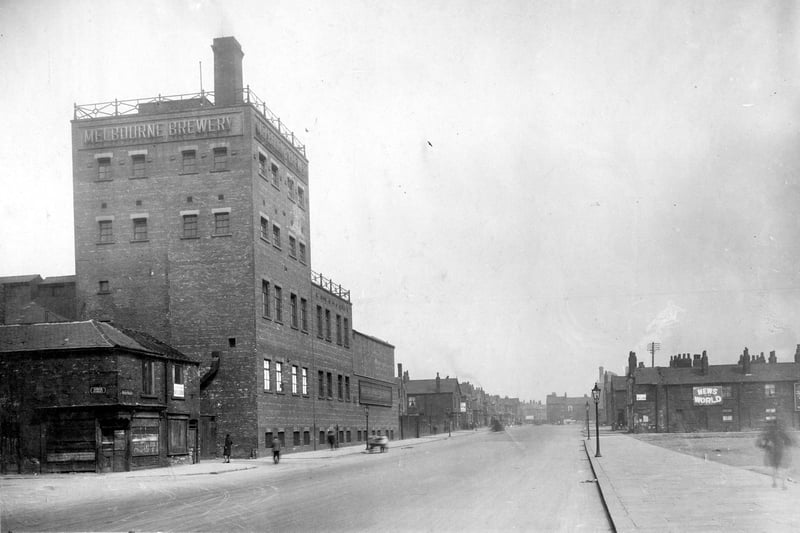To the left is the corner of Gower Street the Melbourne Brewery which began in 1846 by Dickenson and Co, Plum Street. In 1875 Kirk Matthews & Co of Leeds took over merging then with Carter & Co of Leeds and Wakefield. Various changes of management until 1960 when Tetley's bought the brewery. It was demolished in 1973. To the right the waste land was formerly Rose Street, Pink Street and Tulip Street.
