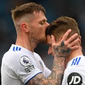 LEEDS, ENGLAND - MAY 23: Gaetano Berardi of Leeds is kissed by Liam Cooper (l) after he leaves the pitch after his last match for Leeds during the Premier League match between Leeds United and West Bromwich Albion at Elland Road on May 23, 2021 in Leeds, England. (Photo by Stu Forster/Getty Images)