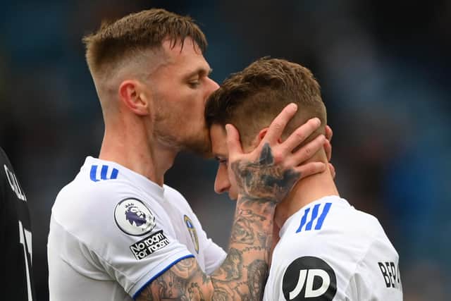LEEDS, ENGLAND - MAY 23: Gaetano Berardi of Leeds is kissed by Liam Cooper (l) after he leaves the pitch after his last match for Leeds during the Premier League match between Leeds United and West Bromwich Albion at Elland Road on May 23, 2021 in Leeds, England. (Photo by Stu Forster/Getty Images)