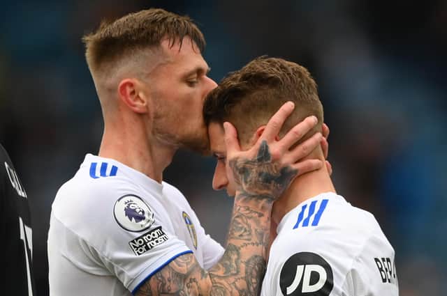 LEEDS, ENGLAND - MAY 23: Gaetano Berardi of Leeds is kissed by Liam Cooper (l) after he leaves the pitch after his last match for Leeds during the Premier League match between Leeds United and West Bromwich Albion at Elland Road on May 23, 2021 in Leeds, England. (Photo by Stu Forster/Getty Images)