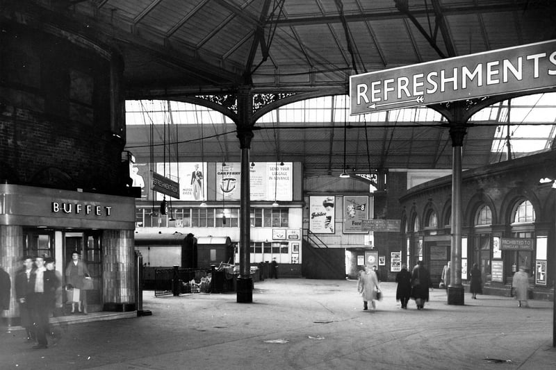 Interior view of Leeds City Station showing the buffet and refreshment rooms to the left and entrances to the platforms on the right. This part of the station was originally New Station, dating from 1869 and built as a joint station for the North-Eastern & London & North-Western Railways. The building of the New Station necessitated spanning the River Aire and the Leeds & Liverpool Canal so it was constructed on a series of arches. These became known as the "Dark Arches", latterly "Granary Wharf". By 1904, as shown on a plan from that time, it had more than doubled in size and included 11 platforms, waiting rooms, refreshment rooms for dining and tea, a ladies' cloakroom, a book stall and public lavatories. In 1937 work began on the amalgamation of New Station (City South) with Wellington Station (City North) to become City Station and construction included the north concourse, linking the two, and a new 200 bedroomed Queens Hotel. It was renamed Leeds City Station on May 2, 1938.