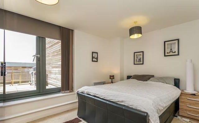 The flat boasts a double bedroom with doors leading to the balcony and a second guest bedroom/study.