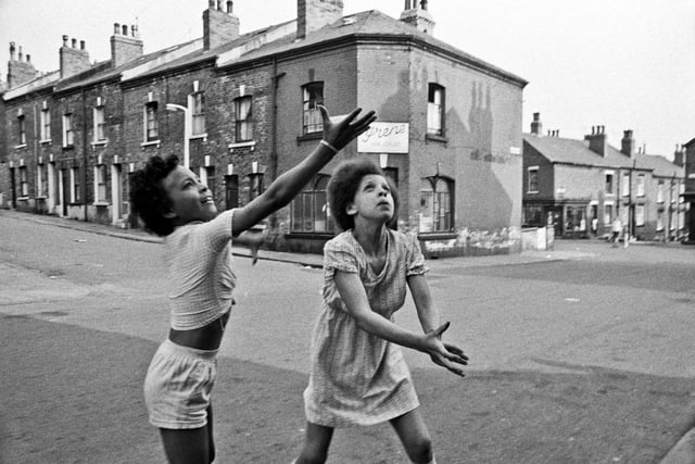 Two girls playing out in the street by the junction of Hartwell Road (left) and Queen's Road (right).