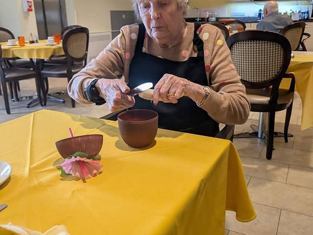 Resident enjoying cocktail and mocktail bar making workshop at HC-One’s Augustus Court Care Home during Care Home Open Week