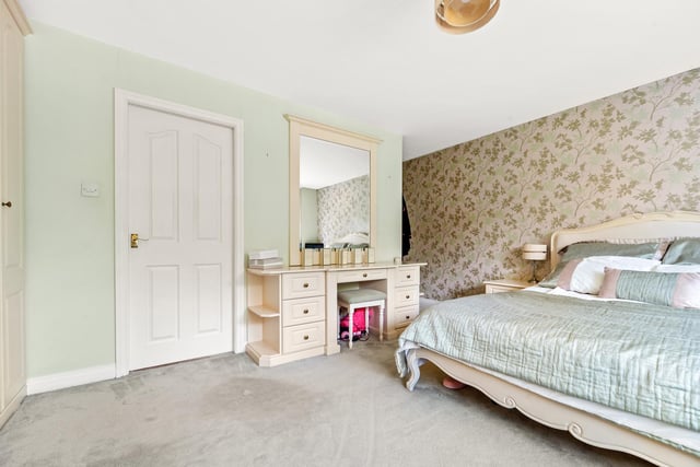 The master bedroom has an ever-changing green outlook with stunning garden and field views, and built-in storage cupboards.