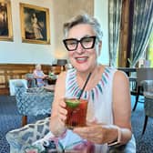 Karen Wright raising cocktail glass to summer