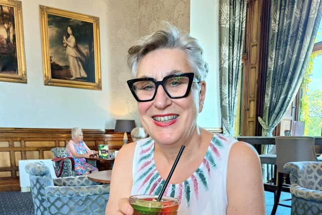 Karen Wright raising cocktail glass to summer