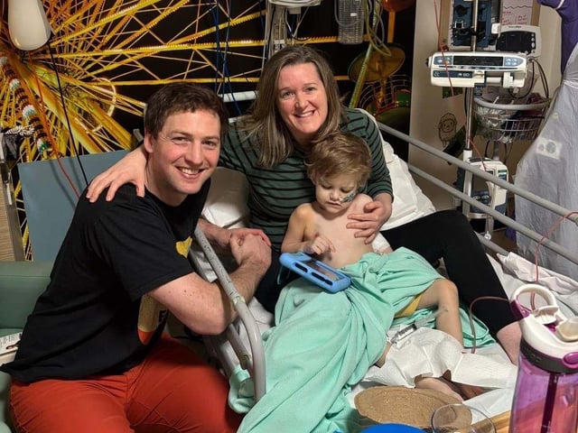 Finn and his parents Tom and Dee, during treatment.