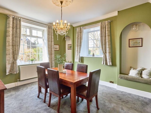 Unique arched alcoves in the dining room have been fashioned into additional seating spots and there is a traditional 1920’s style chandelier hung from the ceiling.