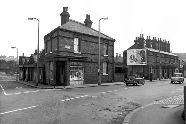 Woodhouse Street is on the left, on the horizon can be seen Sugar Well Hill and council flats which would be on Scott Hall Road. The right side of Woodhouse Street has properties which number 53-59. The shop at the corner with Cambridge Road is number 61, a drapers business. Cambridge Road is to the right and can be seen as far as Walter Grove. Pictured in August 1967.