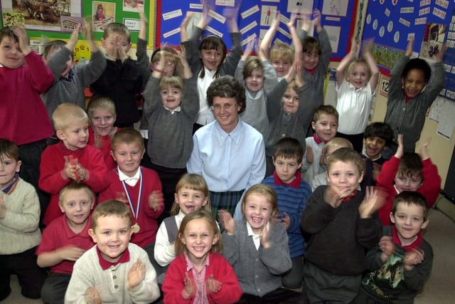 Teacher Pauline Bannister celebrated her long service award from Education Leeds with pupils at Raynville Primary in February 2003 . She had been working for 34 years in the profession.