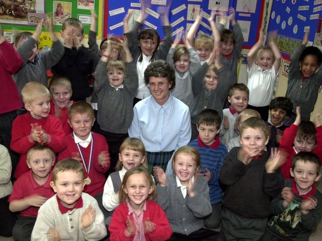 Teacher Pauline Bannister celebrated her long service award from Education Leeds with pupils at Raynville Primary in February 2003 . She had been working for 34 years in the profession.