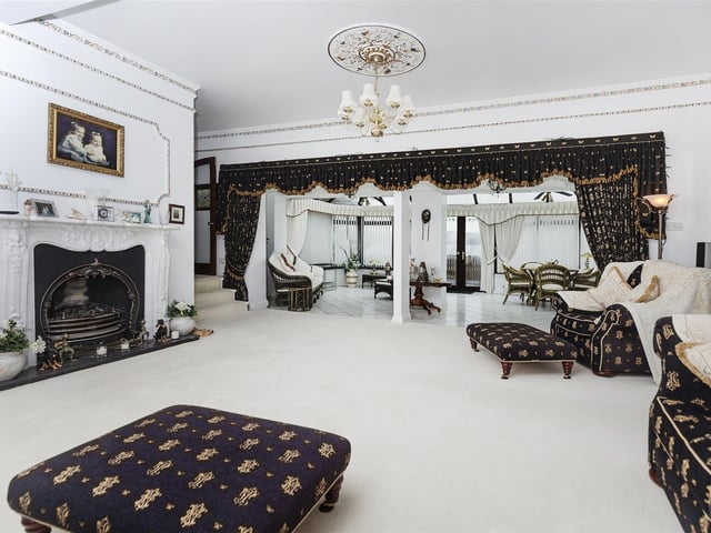 This lavish lounge is open to the conservatory beyond.