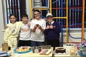 Twins Lola and Ted Wilson, joined by classmates Isaac Dixon and Charlie Weaver, proudly sell their homemade treats at the school’s charity bake sale.