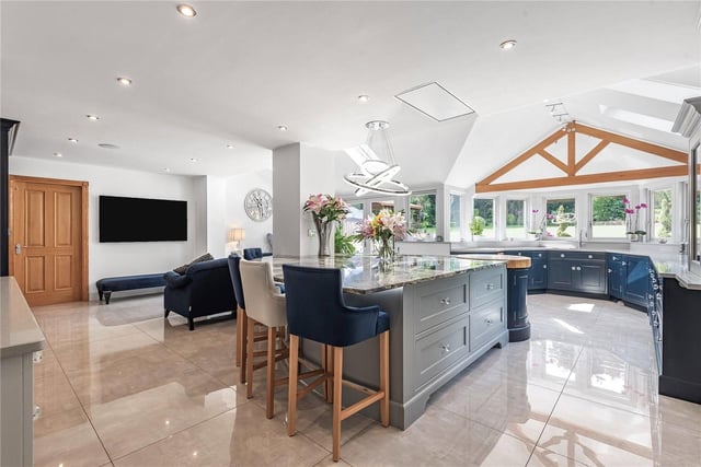 The stunning, open plan living/breakfast kitchen has been designed by Jeremy Wood Interiors. It features a magnificent central island unit with Italian marble top and a wealth of high quality solid wood storage units.