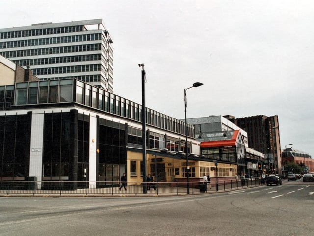 A side view of the Merrion Centre from the corner of Woodhouse Lane and Merrion Street. Ritzy's nightclub to left, in the distance is Fairfax House.