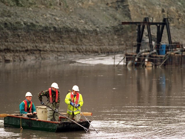 A fisheries team from the Environment Agency  looking for fish  in a draining lagoon at the opencast mine site at Swillington in November 1997.