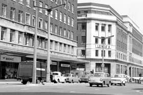 This view from June 1967 looks across The Headrow from the junction with Albion Street. To the left is Headrow House with shops on the ground floor including B.O.A.C. at number 34 and Vallance's radio and television engineers. On the right is Lewis's department store. Originally Woodhouse Lane continued from Merrion Street, running between these two buildings to join The Headrow. The area was later widened to accommodate the St John's Centre and Dortmund Square.