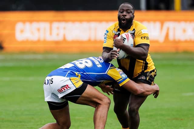 Muizz Mustapha is tackled by Kallum Watkins during Castleford Tigers' defeat to Leeds Rhinos at the Jungle in May. Picture by Alex Whitehead/SWpix.com.