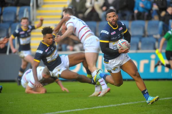 Leon Ruan's pass sends Kruise Leeming in for a try in Rhinos' Boxing Day clash with Wakefield. Picture by Steve Riding,