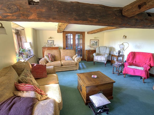 The rustic and roomy lounge within the cottage.