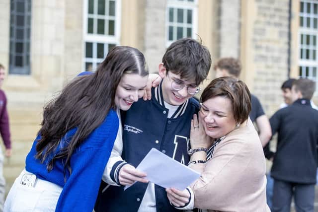 Bradford Grammar School pupil Oles celebrates his results with sister Yaryna and mum Mila
