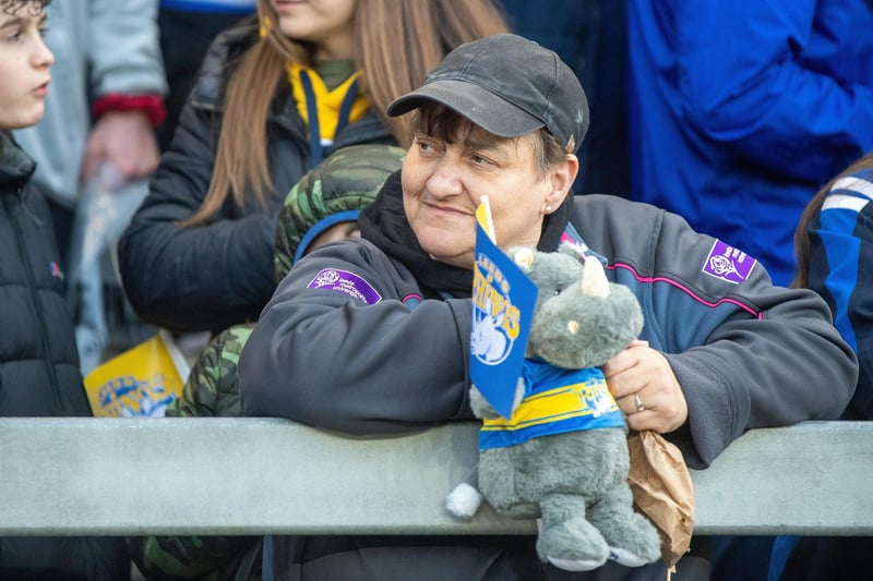 A Rhinos fan - and mascot - take in the AMT Headingley atmosphere before the clash with Warrington.