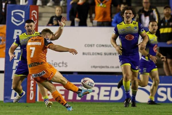Tigers' Danny Richardson lands what proved to be the winning drop goal against Warrington. Picture by Paul Currie/SWpix.com.