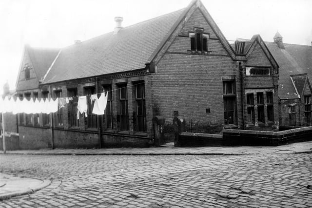 St Luke's School at the corner of St Luke's Grove (left) and Back Malvern Road (right). Clothes hang on a line stretched across St Luke's Grove. The word Infants is spelled out in stone on the Back Malvern Road side of the building showing this to be the infants section of the school. Pictured in June 1973.