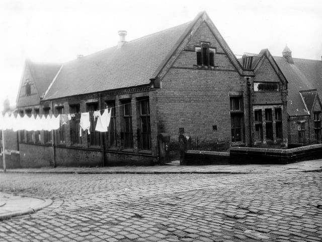 St Luke's School at the corner of St Luke's Grove (left) and Back Malvern Road (right). Clothes hang on a line stretched across St Luke's Grove. The word Infants is spelled out in stone on the Back Malvern Road side of the building showing this to be the infants section of the school. Pictured in June 1973.