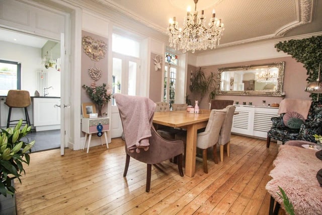 Heading towards the back of the property is a stunning dining area, boasting an open fireplace, wonderful ceiling coving and three double glass doors leading to the kitchen.