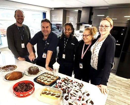 Employees at Lubrizol enjoy a bake sale to raise money for Happy Days Children's Charity.