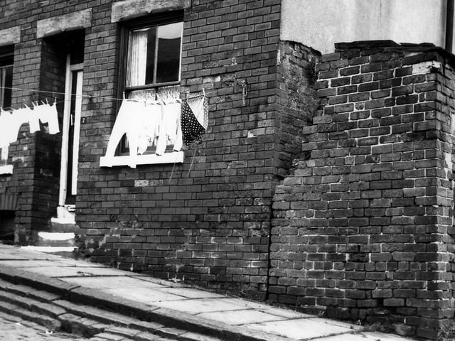 Washing hangs across Viscount Street in August 1965. An outside toilet block can be seen on the right edge. This area was redeveloped after slum clearance with the North West Leeds Working Men's Club now occupying this site.
