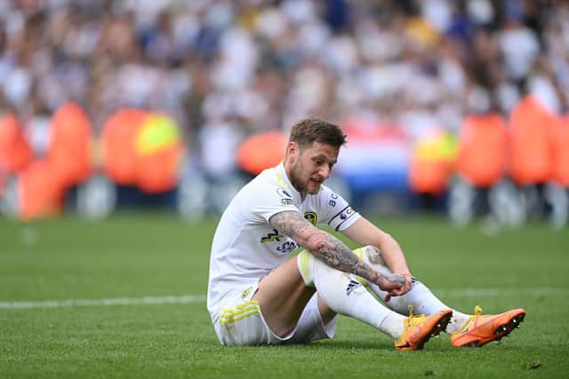 LEEDS, ENGLAND - MAY 15: Leeds United captain Liam Cooper reacts on the final whistle after the Premier League match between Leeds United and Brighton & Hove Albion at Elland Road on May 15, 2022 in Leeds, England. (Photo by Stu Forster/Getty Images)