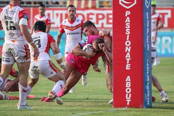 Sam Walters scores for Rhinos under pressure from Catalans' Joe Chan. Picture by Manuel Blondeau/SWpix.com.