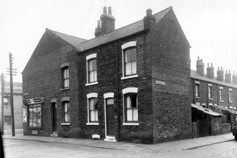 The junction of Hazelhead Street with Atkinson Street. The building to the far left is part of Albion Glass Works, the shop on the corner of Hazelhead Street is T. Gregory, Grocers, then number 1 & no 3 Hazelhead Street can be seen. Looking down Atkinson Street on the right towards South Accomodation Road, brick built outside toilets can be seen in the yard of houses.