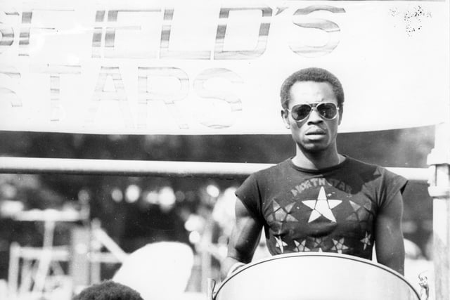 A Pan player of Huddersfield's North Stars Steel Band, here for the 13th Leeds West Indian Carnival. The photograph has been taken in Potternewton Park, the assembly point for the bands, troupes and individuals taking part in the carnival procession on August Bank Holiday Monday, 1980.