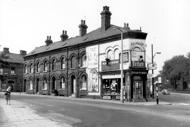 On the left is Oakfield Street, the row of houses on Cambridge Road begins with 8, then moving right 6, 4, and 2 next to the off licence shop. This was the business of Edward Motan and was 177 Meanwood Road. There are numerous signs for beer around the shop including Tetleys. On the right is Meanwood Road, the trees were in front of Meanwood Road Swimming Baths.